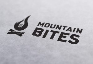 rustic resturant logo, adventure, fire, fork, mountains, bites, adirondack
